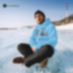 Boy with a personalized hoodie sitting on ice