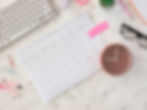 Calendar in a desk with a keyboard and other office supplies