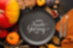 A plate with a Happy Thanksgiving Day text, with a Thanksgiving background