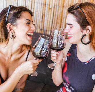 two friends with personalized wine glasses